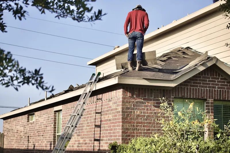 Professional roofer working on a residential roof in Clover Park